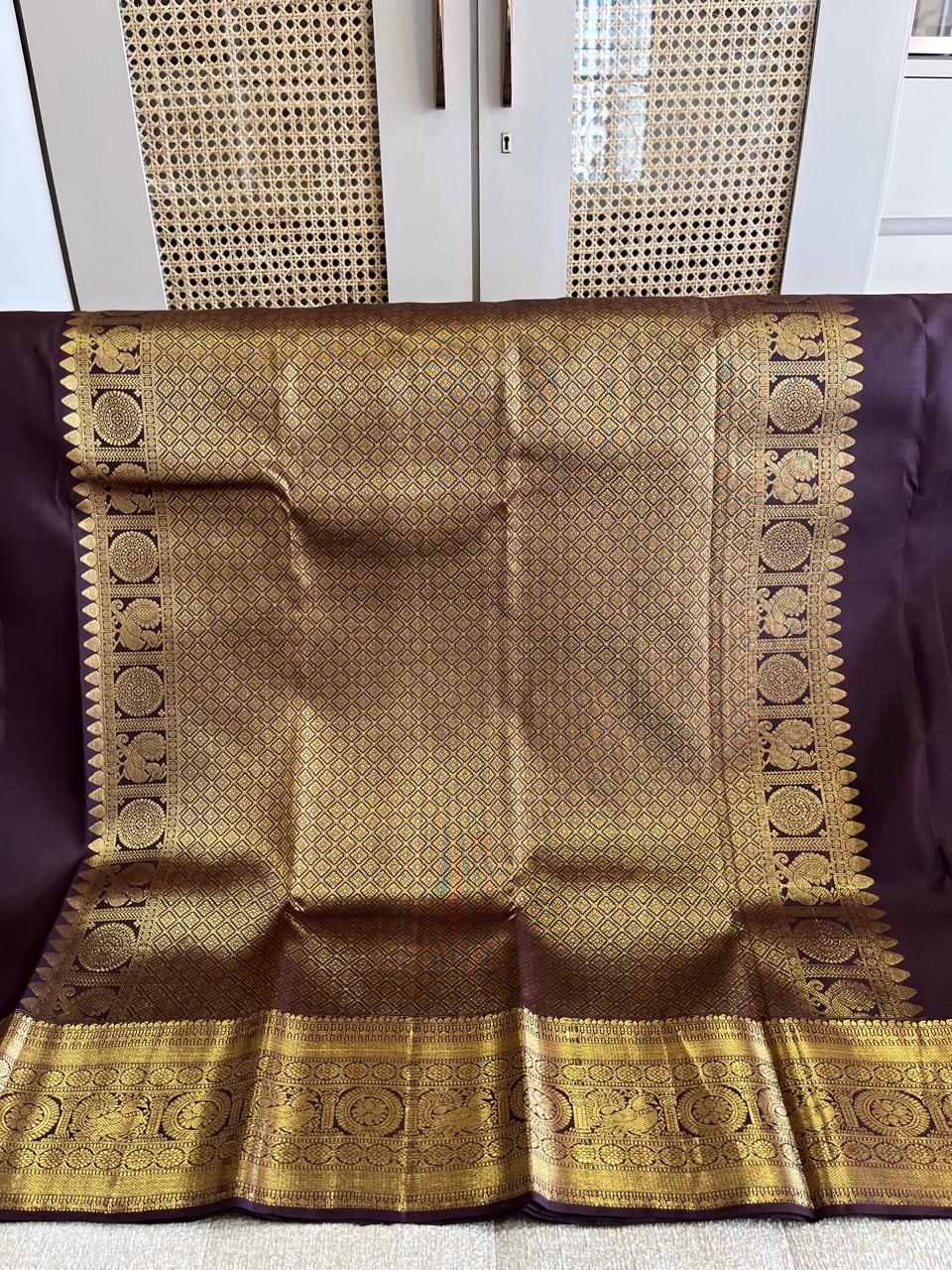 Kasturi: Coffee-Brown Kanjeevaram, Peacock-Coin Buttis